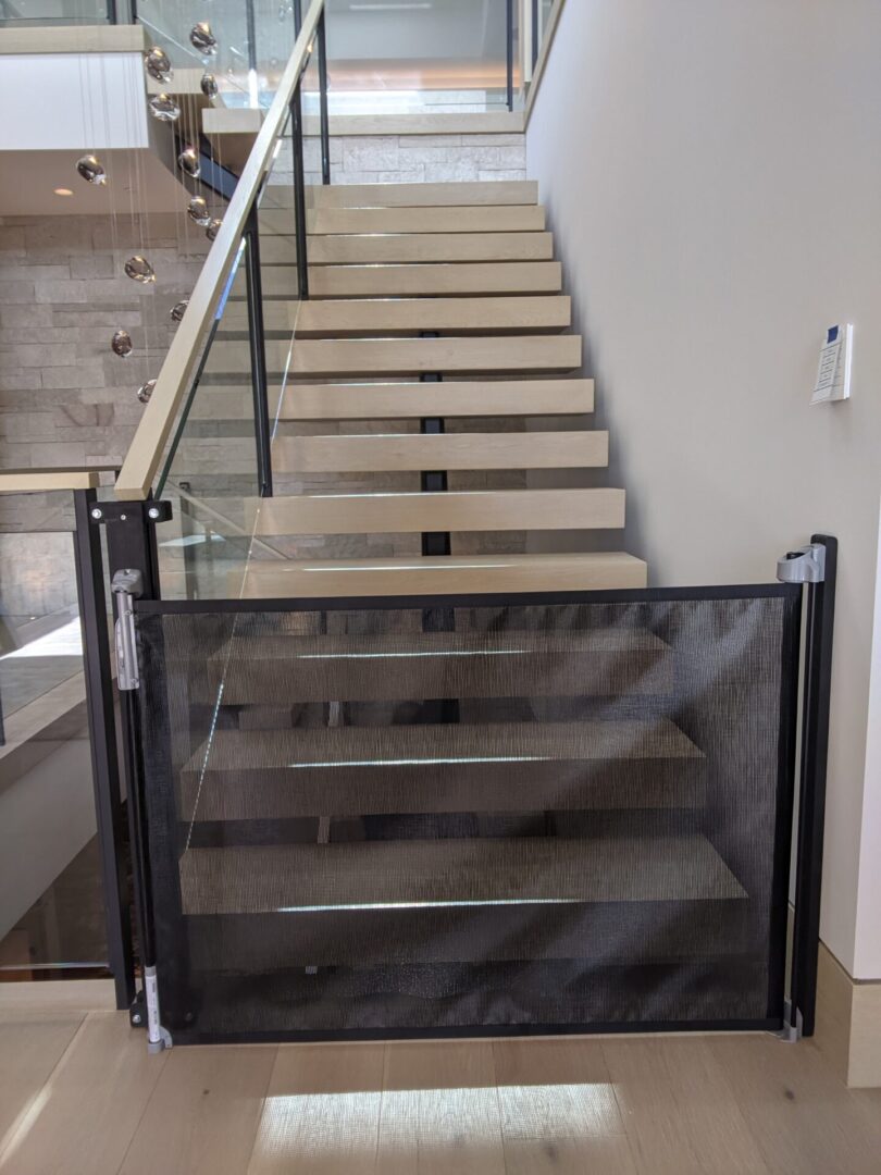 Staircase with a black child safety gate.