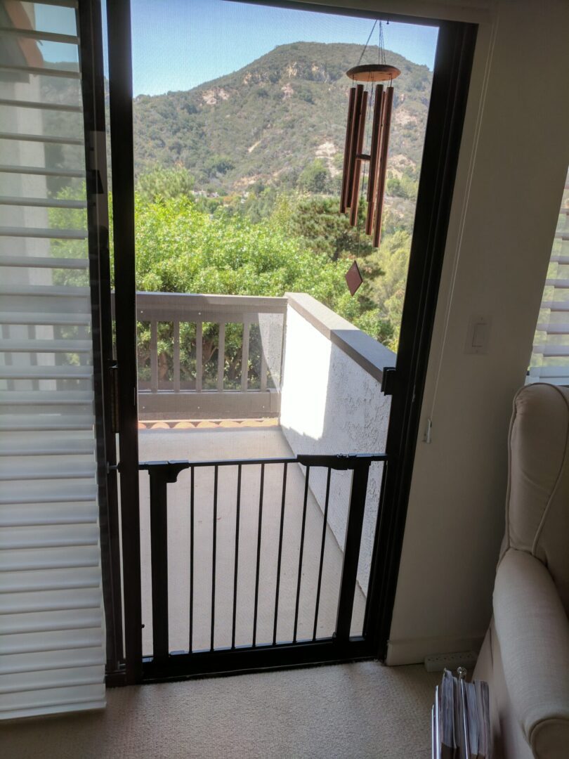 Mountain view from open doorway with chimes.