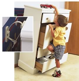 Child climbing dresser with safety latch.