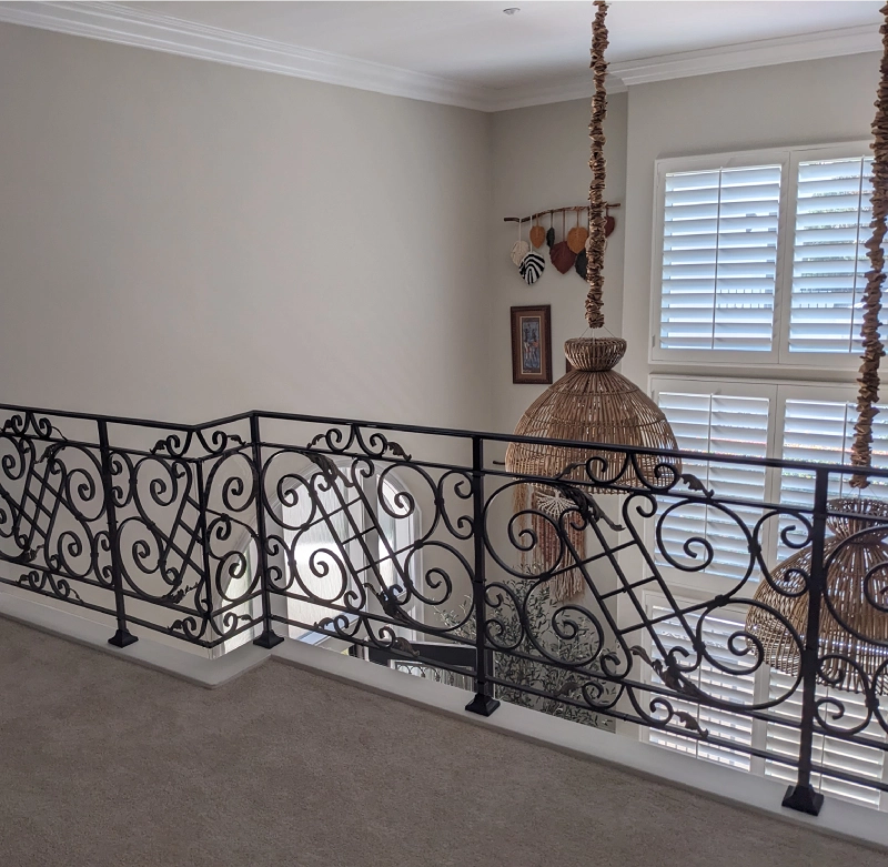 Ornate railing with decorative hanging items.