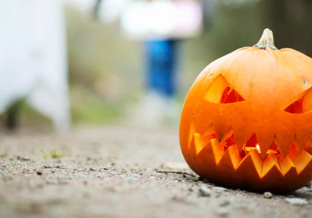 Jack-o'-lantern on a dirt path.